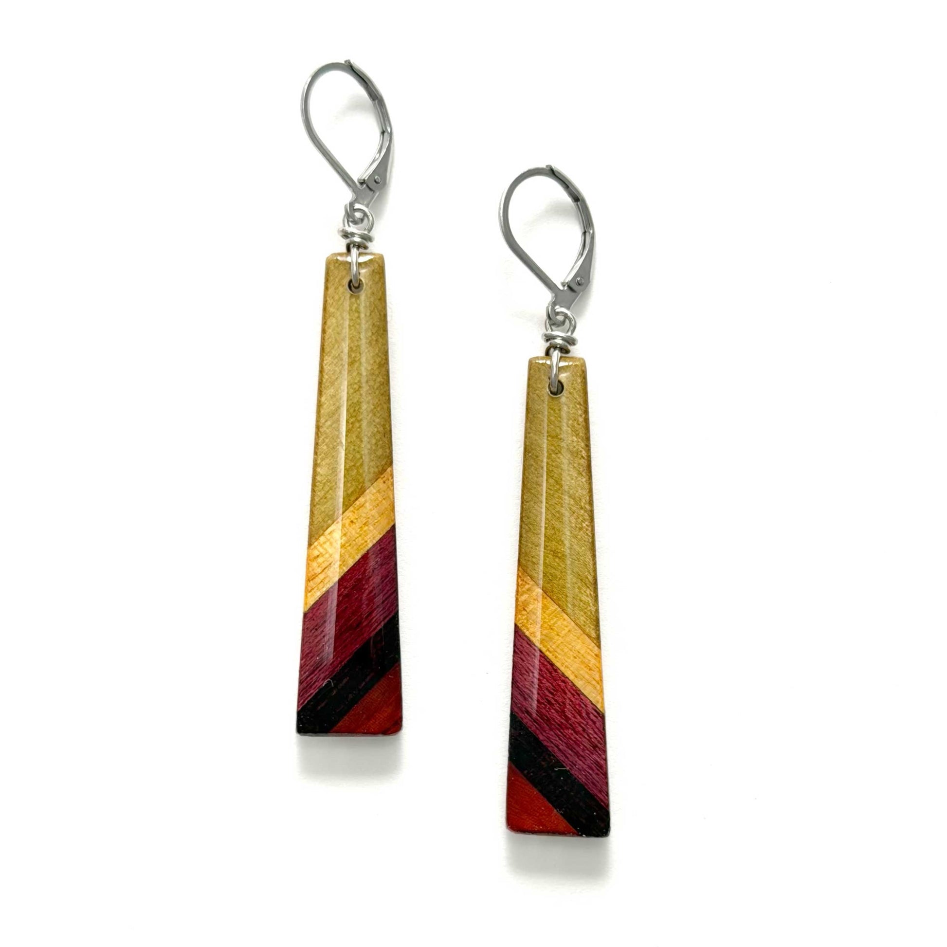 Pair of earrings with striped yellow, red, and black design on a white background